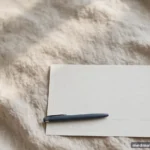 A pen resting beside a blank signature line on an empty form, close view, no legible text