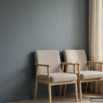 Two empty chairs side by side in soft window light, gentle and calm, no people